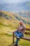 Solitary Figure Absorbing the Stunning Mountain Vista from Secluded Wooden Bench