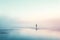 Solitary figure standing in serene, misty waterscape with ethereal light. Digital illustration.
