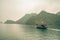 A solitary fishing boat in Ha Long Bay Vietnam