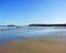 Solitary footprints cross the fresh sand towards the lighthouse at Godrevy near St Ives Cornwall