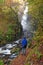 Solitary man looking up at Grey Mare`s Waterfall in Kinlochleven, Scottish Highlands