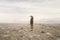 Solitary man looks at the infinite in a surreal and spectacular landscape