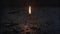 a solitary matchstick igniting, casting a small beacon of light amidst the engulfing darkness, capturing the intricate