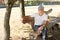 Solitary middle-aged man sitting on a bench