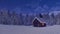 Solitary mountain cabin at snowfall winter night