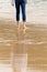 Solitary person walking - wading in incoming waves