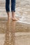 Solitary person walking - wading in incoming waves