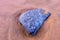 A solitary rock on a sandy beach