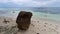 Solitary Rock Sits on White Sand Beach