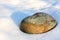 Solitary rock surrounded by snow