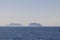 Solitary sailboat with red sail in calm North Sea, Lofoten backdrop