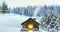 Solitary snowbound half-timbered rustic house decorated for Christmas among snow-covered fir tree forest at snowfall winter night