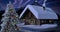 Solitary snowbound half-timbered rustic house decorated for Christmas among snow-covered fir tree forest at snowfall winter night