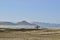 Solitary surfer carrying surf board walks along beach on coast Baja Californ