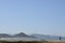 Solitary surfer carrying surf board walks along beach on coast Baja Californ