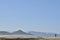 Solitary surfer carrying surf board walks along beach on coast Baja Californ