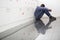 Solitary university student sitting on the floor