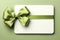 Solitary white backdrop showcases gift card, featuring delicate green ribbon bow.