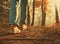 A solitary woman or man, dressed in denim jeans andsneakers, strolls along the pathway within the park.