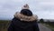 Solitary woman walking through isolated countryside road in Yorkshire England