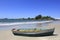 Solitary wooden fishing boat at sea beach with beautiful sky