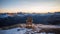 Solitude\\\'s Embrace: A Wooden Chair at Sunset on an Alpine Mountain Peak