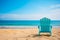 Solitude by the Sea: Vacant Lounge Chair on Sunlit Beach.