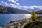 Solo Backpacker Trekking on the mountain in autumn trought foliage, lake, yellow, and orange colors