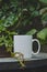 A solo blank white coffee mug on the rusty table edge