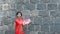 Solo female tourist in chinese traditional clothing with stone wall