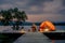 Solo Female Travelers Camping on Wooden Pier, Sit Relaxing with a Natural Reservoir and Looking to the Natural Overview in the