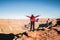 Solo girl traveler spreading her arms by the edge of a cliff being inspired by the scenic view of Grand Canyon West Rim, Arizona,