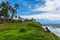 Solo girl traveler standing on a cliff at a beach town called Varkala in Kerala, India