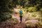 Solo hiker walking on trekking trail in forest