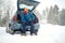 Solo indian man traveller camping through an evergreen winter forest in Canada