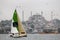 A solo sailor arriving Istanbul for finish and Hagia Sophia and city view is at the background, Turkey.