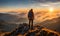 Solo traveler with a backpack standing on a mountain peak at sunrise