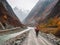 A solo traveler on a bicycle is going through a mountainous area.