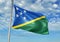 Solomon Islands flag waving with sky on background realistic 3d illustration