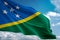 Solomon Islands national flag waving blue sky background realistic 3d illustration