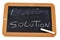 The solution written in french on a school slate