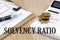 SOLVENCY RATIO text with chart and calculator and coins , business concept