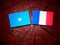 Somalian flag with French flag on a tree stump isolated