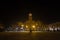 Sombor City Hall, also called gradska kuca, at night, during a foggy evening, with pedestrians passing in speed blur.