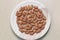 Some almonds in a wooden bowl view from above