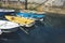 Some boat bright colors on background blue water lake of pier, fishing and boating on summer landscape, holiday travel and sun