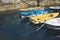 Some boat bright colors on background blue water lake of pier, fishing and boating on summer landscape, holiday travel and sun