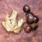 Some Chestnuts on Brown Cloth Background with Leaves and raw Sh