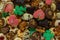 Some of Christmas cookies stored on a gold bowl of candy of different kinds of colors and shapes superimposed on each other on a