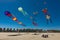 Some colorful kites flying on the beach